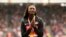 FILE - United States' Tori Bowie gestures after receiving the gold medal she won in the women's 100m final during the World Athletics Championships in London, Aug. 7, 2017. 