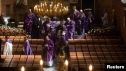 Clergy officiate at a funeral service ahead of the burial of the skeletal remains of over 700 victims of German mass executions recently discovered in the so-called Valley of Death, in Chojnice, Poland, Sept. 2, 2024.