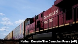 FILE - Canadian Pacific trains sit at the main CP Rail train yard in Toronto, March 21, 2022.