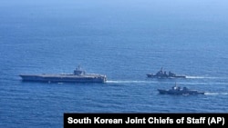 In this photo provided by the South Korean Joint Chiefs of Staff, the USS Carl Vinson, left, sails with South Korean Navy's Aegis destroyer King Sejong the Great, and Japan's Maritime Self-Defense Force Aegis destroyer Kongou during a 2024 joint drill.