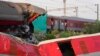 A passenger train passes by the site where two passenger trains derailed Friday in Balasore district, in the eastern Indian state of Orissa, June 5, 2023.