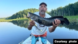 Angler Mike Sielicki holds a northern snakehead fish, which he caught in Potomac Creek in Fredericksburg, Virginia. (Photo courtesy Mike Sielicki) 