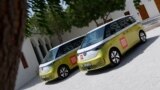 Volkswagen ID. Buzz vehicles are parked outside the venue hosting the Geneve International Motor Show (GIMS) in Doha on Oct. 1, 2023, after crossing through 12 countries to arrive in Qatar from Geneva. 