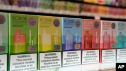FILE - Varieties of disposable flavored electronic cigarette devices manufactured by EB Design, formerly known as Elf Bar, are displayed at a store in Pinecrest, Fla., June 26, 2023. 