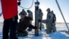 A prototype of a robot built to access underwater areas where Antarctic ice shelves meet land is lowered though the ice during a field test north of Alaska, in March. (US NAVY/SCOTT BARNES/Handout via REUTERS) 