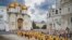 FILE - In this photo released by Russian Orthodox Church Press Service, Orthodox priests and the faithful attend a ceremony in the Kremlin with the Assumption Cathedral in the background, in Moscow, July 28, 2024.