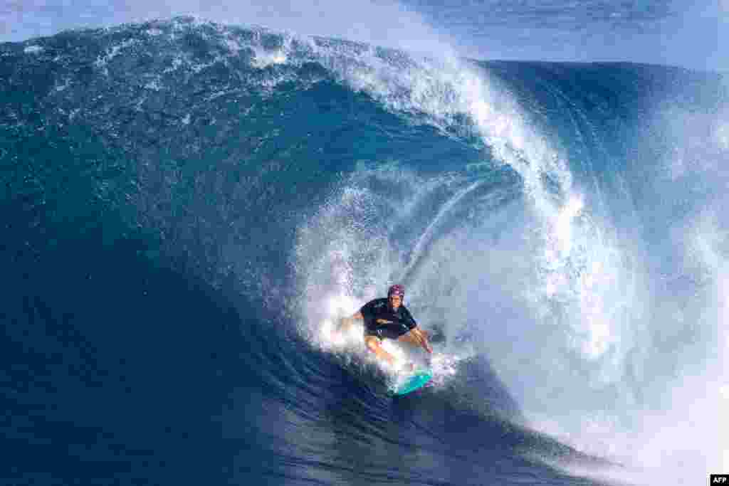 U.S. surfer Koa Smith rides a wave while preparing for the upcoming Vans 2023 Pipeline Masters event at Banzai Pipeline in Haleiwa, Oahu&#39;s north shore, Hawaii, Dec. 4, 2023.