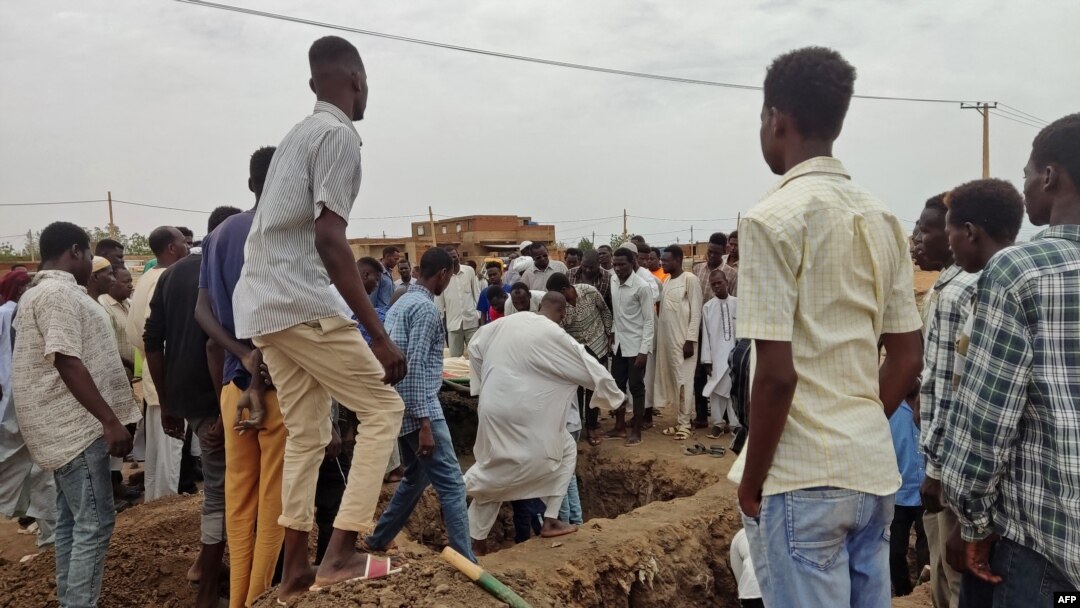 Mourners gather to bury the victims killed by an artillery shell strike in southern Khartoum, Sudan, on June 11, 2023.