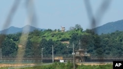 FILE - A North Korean military guard post, upper middle, and South Korean post, bottom, are seen from Paju, South Korea, near the border with North Korea, on Sept. 8, 2023.