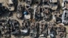 FILE - Israeli security forces inspect charred vehicles burned in the bloody October 7 cross-border attack by Hamas militants, outside the town of Netivot, southern Israel. 