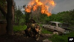 A Ukrainian soldier fires a mortar at Russian positions on the front line near Bakhmut, Donetsk region, Ukraine, May 28, 2023.