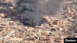 An aerial view of the black smoke and flames from a market in Omdurman, Sudan, May 17, 2023.