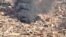 An aerial view of the black smoke and flames from a market in Omdurman, Sudan, May 17, 2023.