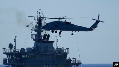Chopper lands marines on combat board during sea training