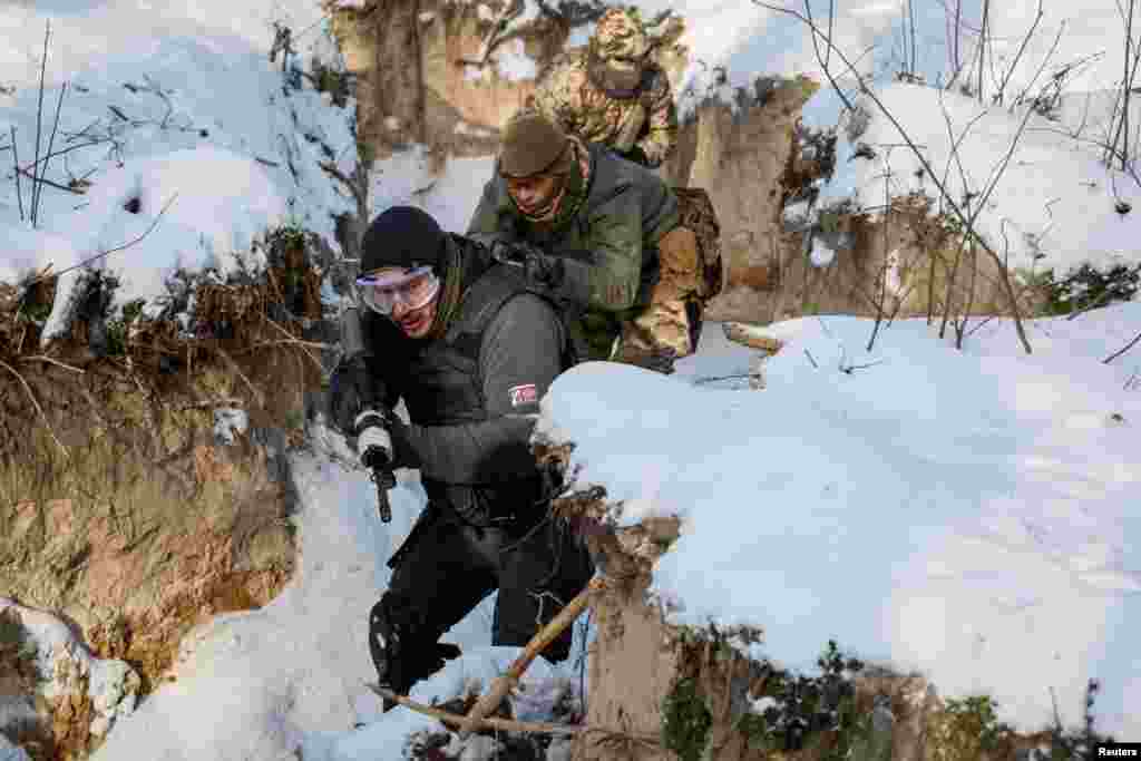 Ukrainian civilians take part in the final exercise of a five-day basic military training, amid Russia's attack on Ukraine, near Kyiv, Ukraine.