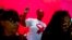 FILE - A woman dances as she listens to music while attending a World AIDS Day commemoration at Nkosi's Haven in Johannesburg on Nov. 30, 2019, on the eve of World AIDS Day.
