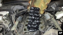 FILE - This Sept. 12, 2021 photo provided by the US Customs and Border Protection Service shows drugs concealed inside the engine of a car. 