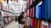 FILE - A vendor arranges textiles at his shop in a market in Algiers, Algeria, Sept. 25, 2023. Algeria has been approved for membership in the BRICS New Development Bank (NDB), the country’s finance ministry has  announced, Sept. 1, 2024.