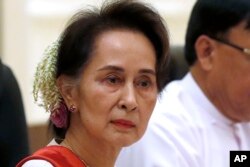 FILE - Myanmar's leader Aung San Suu Kyi, left, in Naypyitaw Myanmar, on Jan. 18, 2020. Thailand’s top diplomat said July 12, 2023, that he met the ousted leader in detention over the weekend and she conveyed her openness to engage in talks to resolve the crisis in her strife-torn nation.