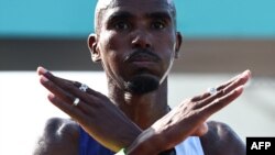 FILE — Britain's Mo Farah reacts after crossing the finish line in 'The Big Half' half marathon in London, on Sept. 3, 2023.