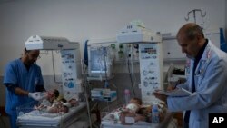 Medics prepare premature babies for transport to Egypt after they were evacuated from Shifa Hospital in Gaza City to a hospital in Rafah, Gaza Strip on Monday, November 20, 2023.