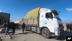 Humanitarian aid trucks enter the Gaza Strip from Israel through the Kerem Shalom crossing, in Rafah, Jan. 14, 2024. 