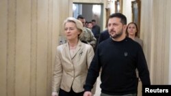 Ukraine's President Volodymyr Zelenskiy and European Commission President Ursula von der Leyen arrive for a press conference, in Kyiv, Nov. 4, 2023. (Ukrainian Presidential Press Service/Handout via Reuters)