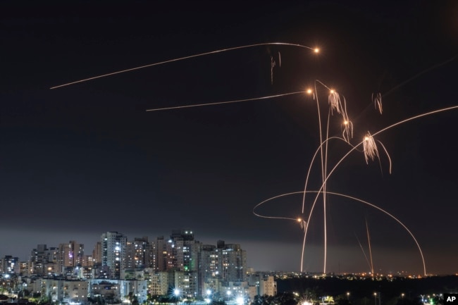 FILE - Israel's Iron Dome missile defense system fires interceptors at rockets launched from the Gaza Strip, in Ashkelon, southern Israel. Thursday, May 11, 2023. (AP Photo/Tsafrir Abayov, File)