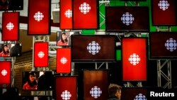 FILE - A man sits inside the Canadian Broadcasting Corp. broadcast center in Toronto, May 23, 2014.