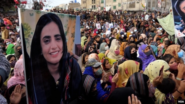 FILE - In this photo taken from video, a placard picturing Baloch Unity Committee leader Mahrang Baloch is displayed by people at a welcome rally for the activist in Quetta, Pakistan, on Jan. 25, 2024.