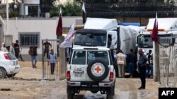 Vehicles of the International Red Cross carrying aid prepare to cross into Rafah in the southern Gaza Strip on Nov. 15, 2023, amid the ongoing battles between Israel and the Palestinian group Hamas.