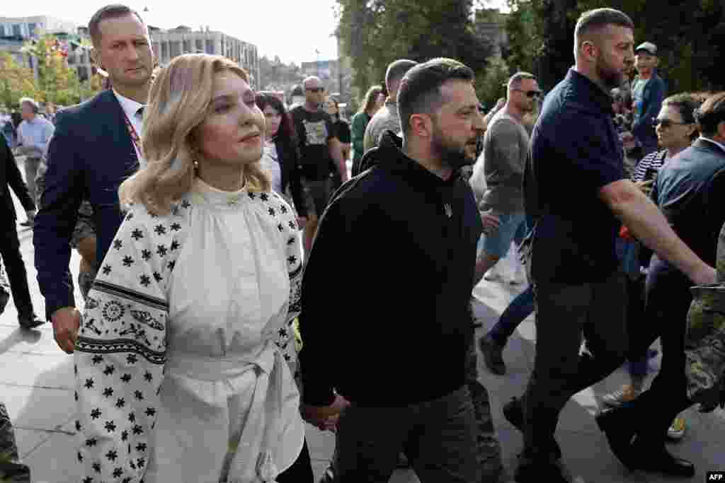 Ukrainian President Volodymyr Zelenskyy (C) and his wife Olena Zelenska arrive to deliver a speech at Lukiskiu Square in Vilnius, Lithuania, on the sidelines of a NATO Summit. 