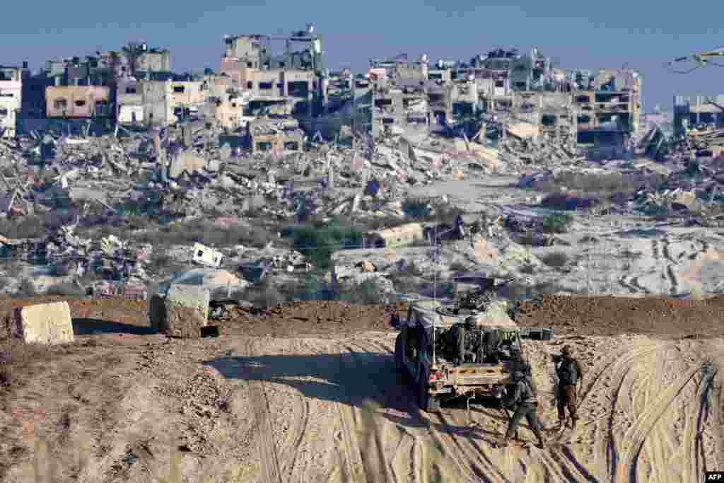 Israeli troops operate on their side of the fence separating Israel from the Gaza Strip amid the ongoing conflict between Israel and the militant group Hamas.