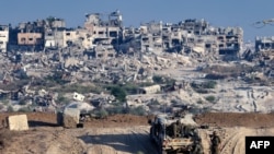 FILE - Israeli troops operate on their side of the fence separating Israel from the Gaza Strip, Aug. 29, 2024, amid the ongoing conflict between Israel and the militant group Hamas. 