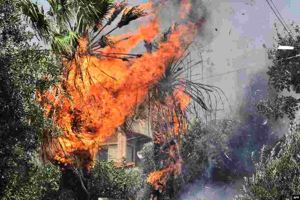 Wildfire burns a house in the settlement of Irini, near the resort town of Loutraki, some 80 kilometers east of Athens, Greece.