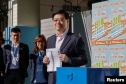 Hong Kong Chief Executive John Lee votes at a polling station during the District Council election in Hong Kong, China, Dec. 10, 2023.