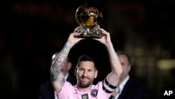 FILE - Inter Miami forward Lionel Messi holds his Ballon d'Or trophy before the team's club friendly soccer match against New York City FC, Nov. 10, 2023, in Fort Lauderdale, Florida. Messi won FIFA’s best men’s player award Jan. 15, 2024. 