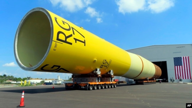FILE - A huge foundation for an Orsted offshore wind turbine, called a monopile, sits atop wheeled movers in Paulsboro, NJ, July 6, 2023.
