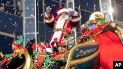 FILE - Santa Claus drives his reindeer and sleigh float along Central Park West during the Macy's Thanksgiving Day parade, Thursday, Nov. 23, 2023, in New York. (AP Photo/Jeenah Moon)
