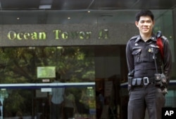 FILE - A Thai police officer stands guard outside a building where the Israeli Embassy is located, in Bangkok, Thailand, Feb. 15, 2012.