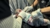 A Palestinian infant wounded in an Israeli strike on a house receives medical attention, after a temporary truce between Hamas and Israel expired, at Nasser hospital in Khan Younis in the southern Gaza Strip, Dec. 1, 2023.