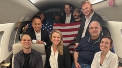 Evan Gershkovich, left, Paul Whelan, second-right, and Alsu Kurmasheva, right, are seen on board a plane in a photo posted by President Joe Biden on X Aug. 1, 2024. The person next to Gershkovich is not identified.