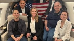 Evan Gershkovich, left, Paul Whelan, second-right, and Alsu Kurmasheva, right, are seen on board a plane in a photo posted by President Joe Biden on X Aug. 1, 2024. The individuals next to and behind Gershkovich are not identified.