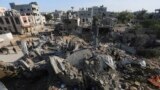Palestinians look at the destruction by the Israeli bombardment of the Gaza Strip 