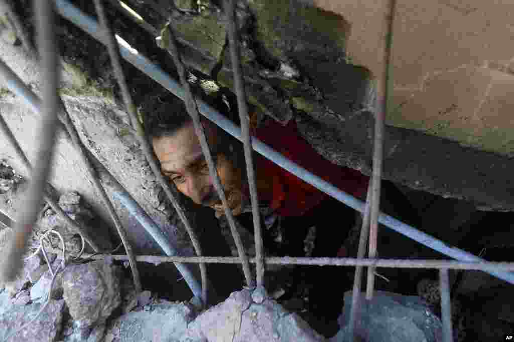 Palestinians look for survivors under the rubble of a destroyed building following an Israeli airstrike in Khan Younis refugee camp, southern Gaza Strip. (AP Photo/Mohammed Dahman)