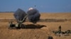 An Israeli mobile artillery unit fires a shell from southern Israel towards the Gaza Strip, in a position near the Israel-Gaza border, Oct. 15, 2023. 