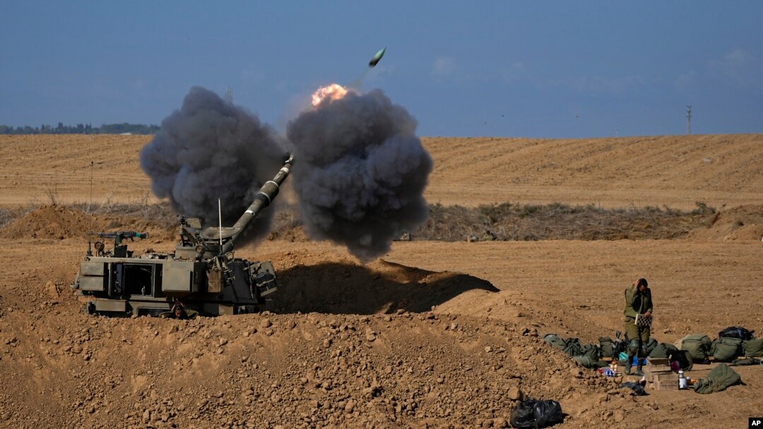 An Israeli mobile artillery unit fires a shell from southern Israel towards the Gaza Strip, in a position near the Israel-Gaza border, Oct. 15, 2023. 