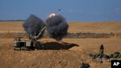 An Israeli mobile artillery unit fires a shell from southern Israel towards the Gaza Strip, in a position near the Israel-Gaza border, Oct. 15, 2023. 