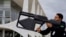 A security guard uses an anti-drone weapon against a drone that was flying near the Planalto Palace and the National Congress in Brasilia, Brazil, Jan. 8, 2024. 