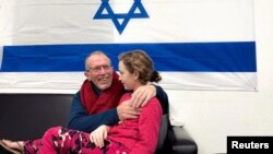 Irish-Israeli girl Emily Hand, who was abducted by Hamas gunmen, is reunited with her father, Thomas Hand, after being released, at an undisclosed location in Israel, in this handout image released Nov. 26, 2023. (Israel Defense Forces/Handout via Reuters)